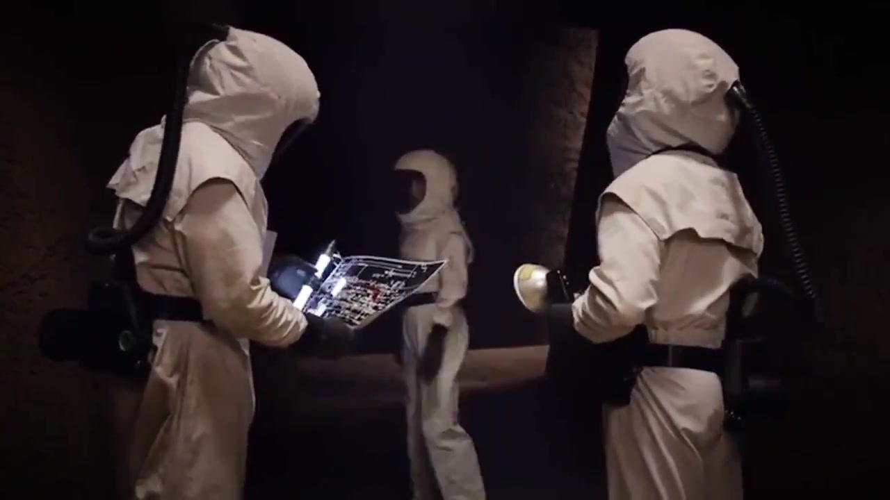 Hazmat-suited scientists searching the dark alien city in Agents of S.H.I.E.L.D. "Aftershocks"