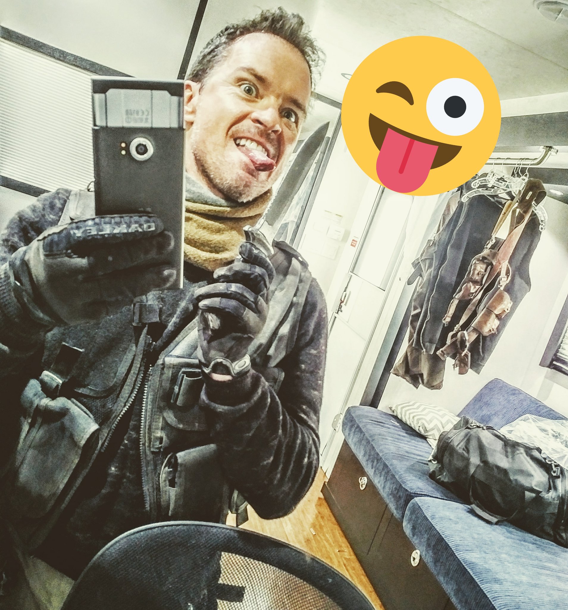 McKay Stewart in his Roughneck costume taking a goofy mirror selfie in his trailer, holding the knife from his costume